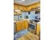 Bright kitchen with stainless steel appliances and wood cabinets at 1775 Cupecoy Cir # O4, Lutz, FL 33558