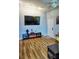 Living room with TV, fireplace, and wood-look flooring at 1775 Cupecoy Cir # O4, Lutz, FL 33558