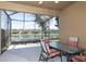 Relaxing screened patio overlooking a lake with seating area at 8636 Tenbridge Way, New Port Richey, FL 34654