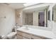 Bathroom with toilet, sink and large mirror at 8833 Manos Cir # 8833, New Port Richey, FL 34655