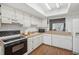 Functional kitchen featuring white cabinets, microwave and dishwasher at 8833 Manos Cir # 8833, New Port Richey, FL 34655