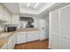 Galley style kitchen with white cabinets and appliances at 8833 Manos Cir # 8833, New Port Richey, FL 34655