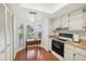 Efficient kitchen with white cabinets, and a window view at 8833 Manos Cir # 8833, New Port Richey, FL 34655
