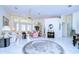 Bright living room features tile floors, comfy seating, and access to a sunroom at 8704 Cypress Lakes Blvd, New Port Richey, FL 34653
