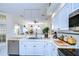 Updated kitchen featuring white cabinets, stainless steel appliances, and a large island at 8704 Cypress Lakes Blvd, New Port Richey, FL 34653