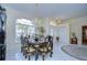 Bright dining room featuring a formal table setting and large window at 8704 Cypress Lakes Blvd, New Port Richey, FL 34653