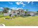 Single-story home with landscaped yard, driveway, and attached garage at 8704 Cypress Lakes Blvd, New Port Richey, FL 34653
