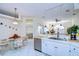 Eat-in kitchen boasts white cabinets, stainless steel appliances, and a breakfast nook at 8704 Cypress Lakes Blvd, New Port Richey, FL 34653
