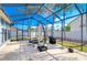Enjoy this large screened patio, perfect for outdoor dining and relaxation at 8704 Cypress Lakes Blvd, New Port Richey, FL 34653