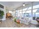 Bright sunroom features tile floors, comfortable seating, and views of the backyard at 8704 Cypress Lakes Blvd, New Port Richey, FL 34653