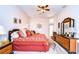Spacious Primary bedroom with a comfortable seating area and dresser at 8704 Cypress Lakes Blvd, New Port Richey, FL 34653