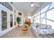 Sunroom with tile floors, ample seating, and sliding glass doors at 8704 Cypress Lakes Blvd, New Port Richey, FL 34653