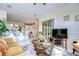Open living area with a view of the kitchen and access to a sunroom at 8704 Cypress Lakes Blvd, New Port Richey, FL 34653