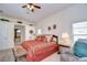 Bright main bedroom with a king-size bed and access to the bathroom at 8704 Cypress Lakes Blvd, New Port Richey, FL 34653