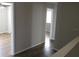 Light-toned hallway with wood-look flooring and access to other rooms at 6109 School House Ct, Wesley Chapel, FL 33545