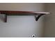 Wooden shelf with a hanging rod in the laundry room at 6109 School House Ct, Wesley Chapel, FL 33545