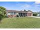 Brick ranch home with attached garage and spacious lawn at 10316 Amadeus Dr, Port Richey, FL 34668