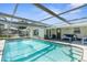 Inviting swimming pool with screened patio at 10316 Amadeus Dr, Port Richey, FL 34668
