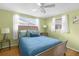 Cozy bedroom with a full bed and light green walls at 10316 Amadeus Dr, Port Richey, FL 34668