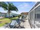 Large backyard with patio furniture and grassy area at 10316 Amadeus Dr, Port Richey, FL 34668