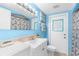 Clean bathroom with light blue walls, white vanity and shower/tub combo at 10316 Amadeus Dr, Port Richey, FL 34668