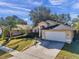 Single-story home with attached garage and landscaping at 13360 Wrenwood Cir, Hudson, FL 34669