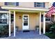 Inviting front entrance with covered porch, brick walkway, and American flag at 15473 Darien Way, Clearwater, FL 33764