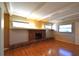 Living room with brick fireplace, hardwood floors, and wood beams at 15473 Darien Way, Clearwater, FL 33764