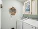 Bright laundry room with washer, dryer, and overhead cabinets at 25157 Alcazar, Punta Gorda, FL 33955