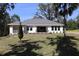 Beautiful backyard showcasing lush lawn, various trees, a patio and a great view at 6392 Summit View Dr, Brooksville, FL 34601