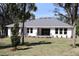 Expansive backyard showcasing lush lawn, various trees and a patio for relaxing or entertaining at 6392 Summit View Dr, Brooksville, FL 34601