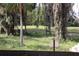 View of the backyard and golf course, featuring a variety of trees and vegetation at 6392 Summit View Dr, Brooksville, FL 34601