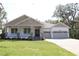 Charming single-story home with a welcoming front porch, manicured lawn, and a convenient two-car garage at 6392 Summit View Dr, Brooksville, FL 34601
