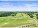 Beautiful golf course view featuring lush greens, sand traps, and well-maintained fairways under a bright blue sky at 6392 Summit View Dr, Brooksville, FL 34601