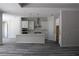 Open concept kitchen featuring white cabinets, stainless appliances and center island with bar seating at 6392 Summit View Dr, Brooksville, FL 34601
