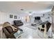 Spacious living area with comfortable leather seating and a large TV at 7310 Rockwood Dr, Port Richey, FL 34668