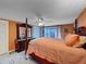 Spacious bedroom with a four-poster bed, dresser, and access to the backyard at 7310 Rockwood Dr, Port Richey, FL 34668