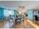 Bright dining room with a table and chairs, hardwood floors, and access to the kitchen at 7310 Rockwood Dr, Port Richey, FL 34668