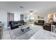 Large living room with leather sofas, a coffee table, and a view of the dining area at 7310 Rockwood Dr, Port Richey, FL 34668