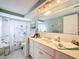 Bathroom with a shower/tub combo and double vanity at 7310 Rockwood Dr, Port Richey, FL 34668