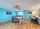 Dining area with light wood floors, a six-chair table, and an open kitchen view at 7310 Rockwood Dr, Port Richey, FL 34668