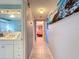 Hallway with tiled floors and view into bedroom at 7310 Rockwood Dr, Port Richey, FL 34668