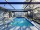 Inviting screened pool with patio furniture at 7310 Rockwood Dr, Port Richey, FL 34668