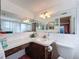 Bathroom with a large vanity, toilet and shower at 7310 Rockwood Dr, Port Richey, FL 34668