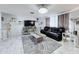 Bright living room featuring a large TV, leather sofa, and tiled floors at 7310 Rockwood Dr, Port Richey, FL 34668