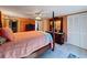 Spacious bedroom with a four-poster bed, dresser, and access to a hallway at 7310 Rockwood Dr, Port Richey, FL 34668