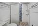 Updated bathroom with a walk-in shower, tile surround, and modern fixtures at 7719 Cosme Dr # 1, Hudson, FL 34667