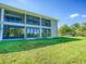Building exterior showcasing a well-maintained lawn and parking area at 7719 Cosme Dr # 1, Hudson, FL 34667