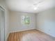Bright bedroom featuring light laminate flooring and a window with natural light at 7719 Cosme Dr # 1, Hudson, FL 34667
