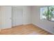 Spacious bedroom with wood-look flooring and a large closet at 7719 Cosme Dr # 1, Hudson, FL 34667